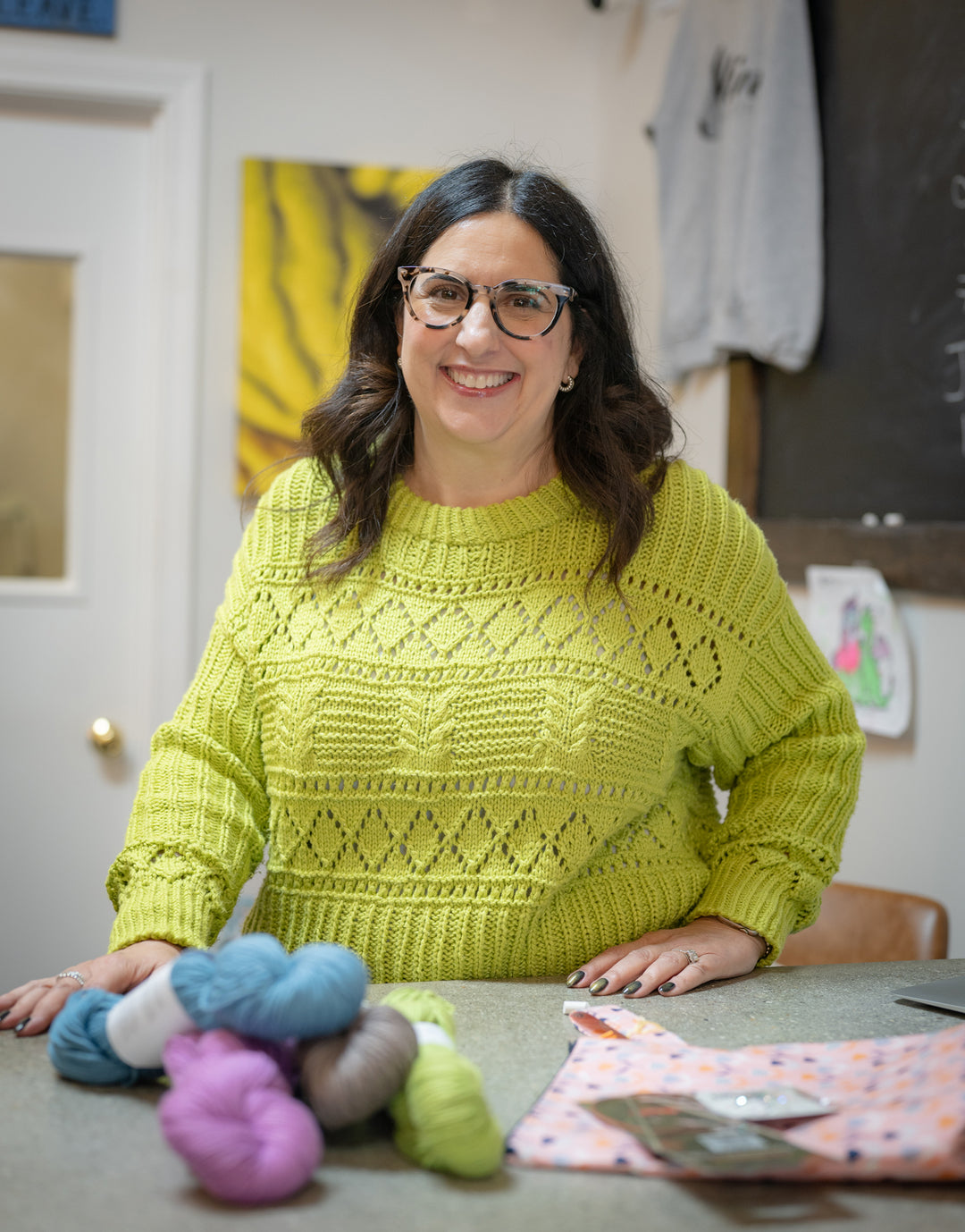 Skein Yarn Shop owner Lori Land inside the East Greenwich yarn shop