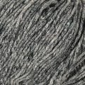 A close up of a tweed yarn that is gray with blips of black in it.