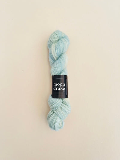 A skein of yarn in a light minty color with a soft halo of texture.