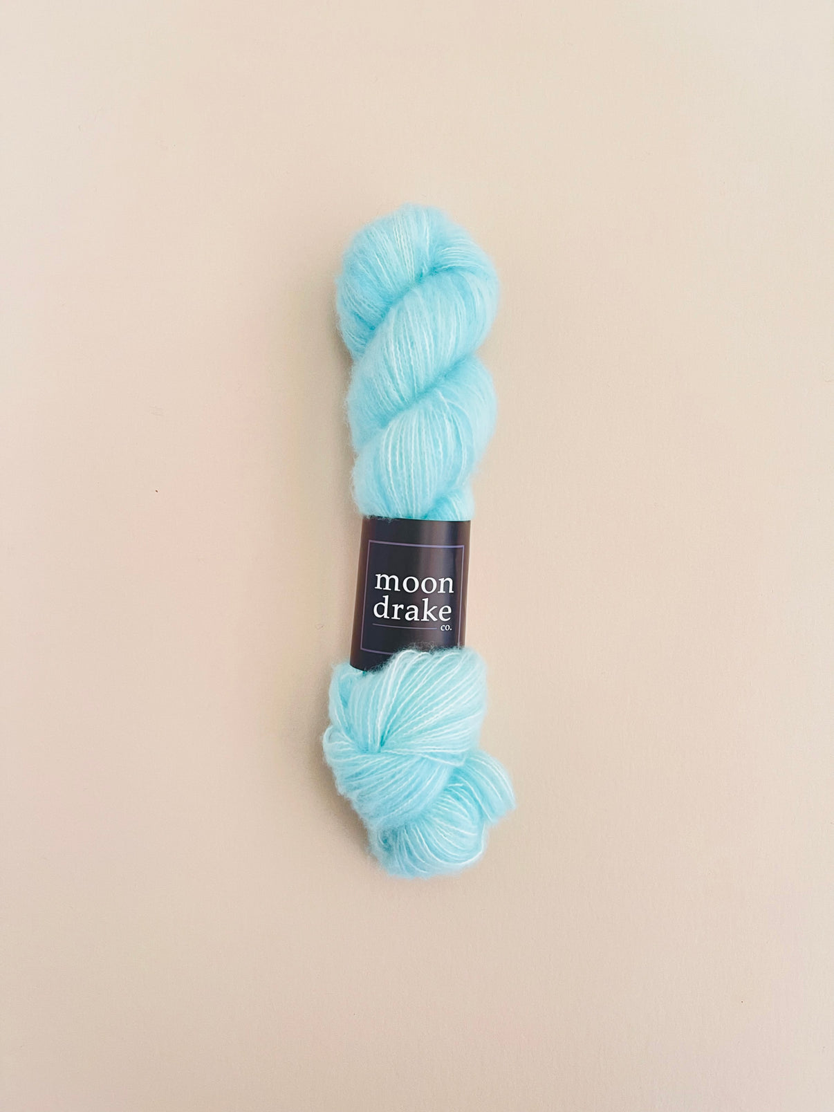 A robin's egg blue skein of fuzzy yarn.