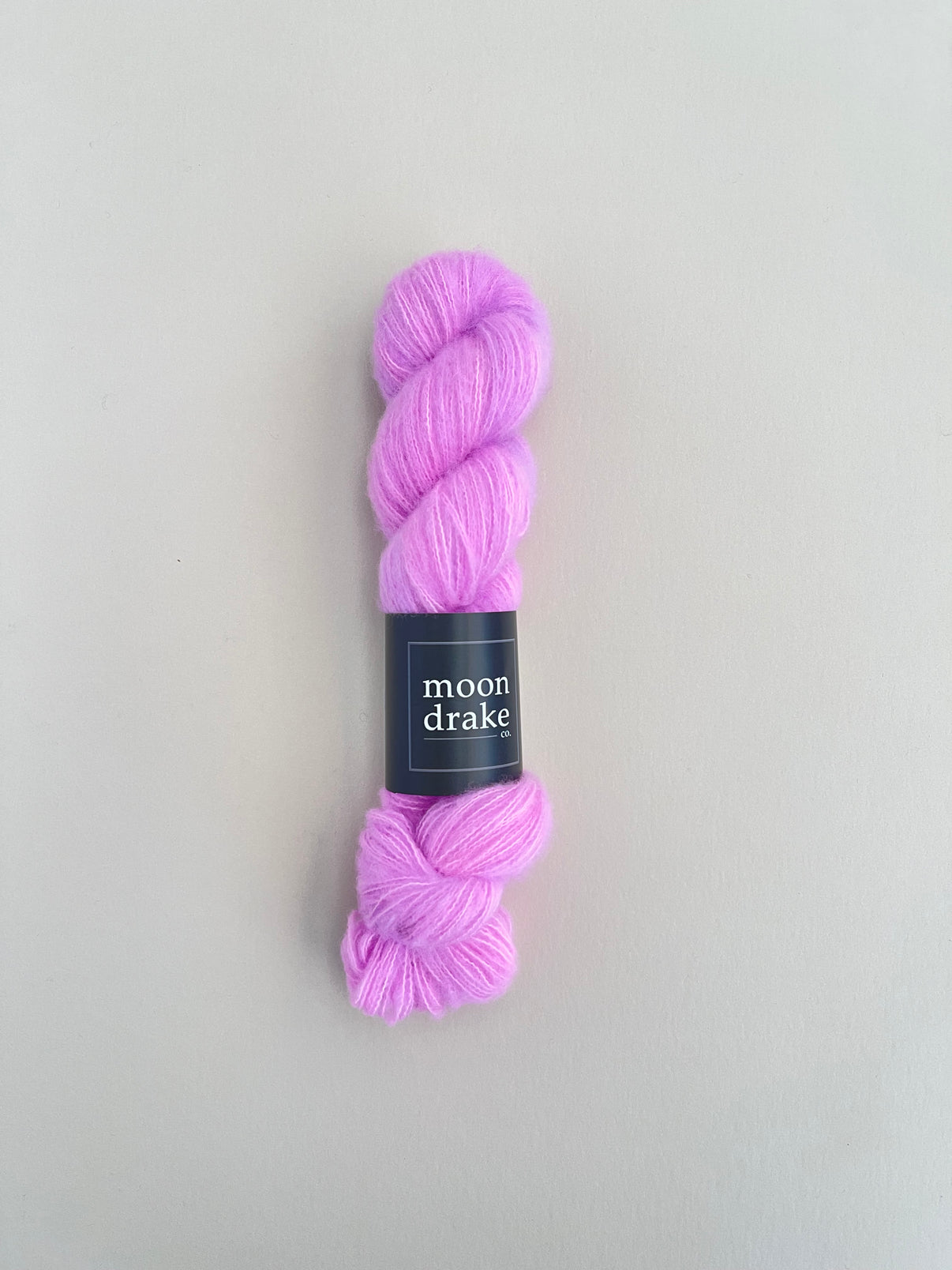 A lavender skein of brushed cashmere yarn with a soft halo of texture.