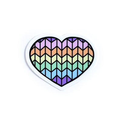 A heart shaped vinyl sticker with a pastel rainbow stockinette stitch pattern on it. 